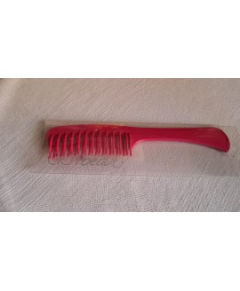 Гребінець із подвійними зубцями з ручкою.